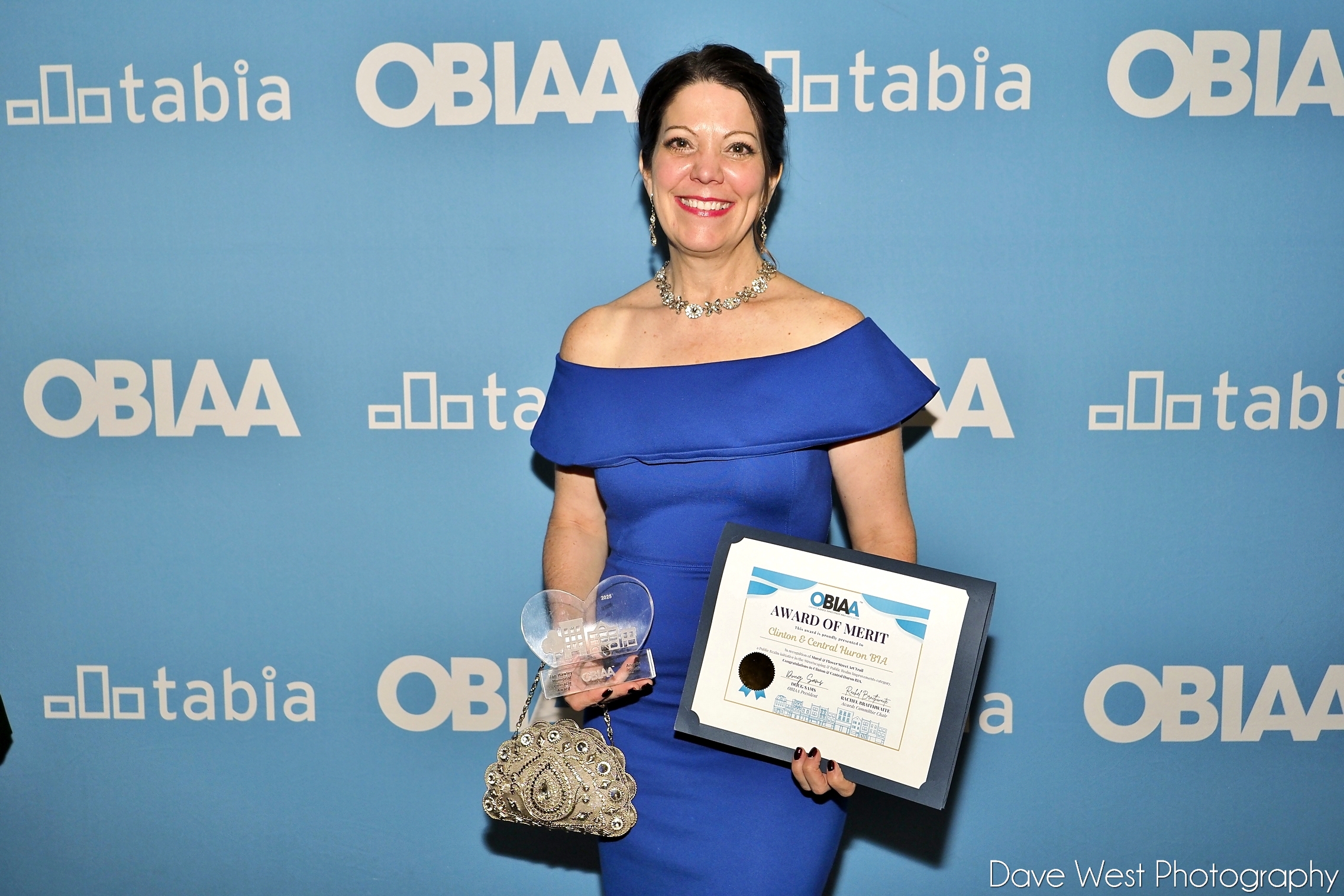 Community Improvement Coordinator Angela Smith holding both awards